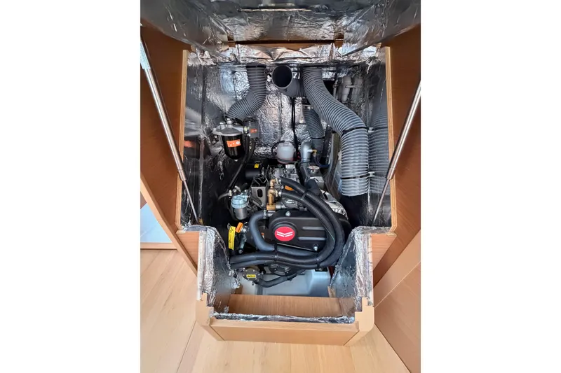 Slide: The Image of Engine compartment of 2025 Jeanneau Sun Odyssey 350 sailboat, showcasing mechanical components. - 90