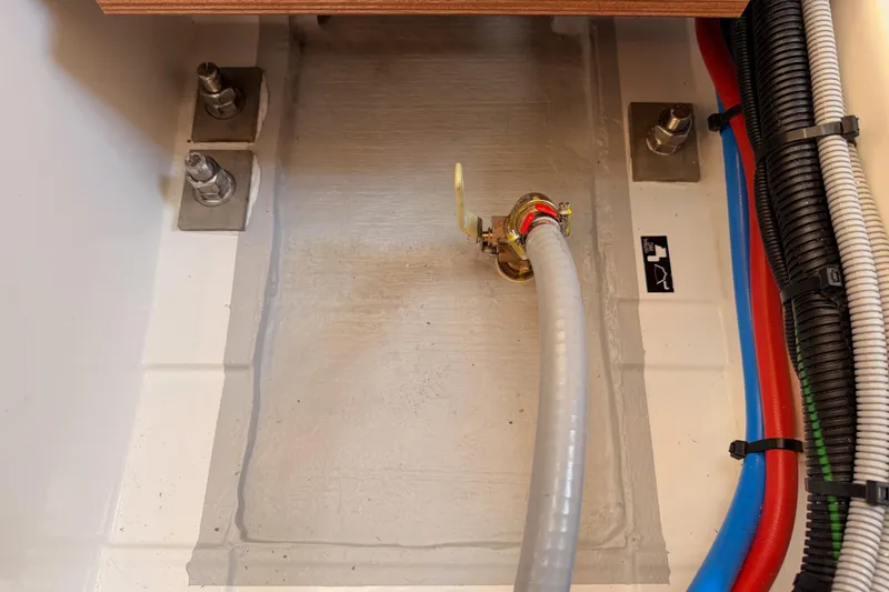 Slide: The Image of Interior view of Jeanneau Sun Odyssey 350 yacht, showcasing plumbing and wiring components, 2025 model. - 96