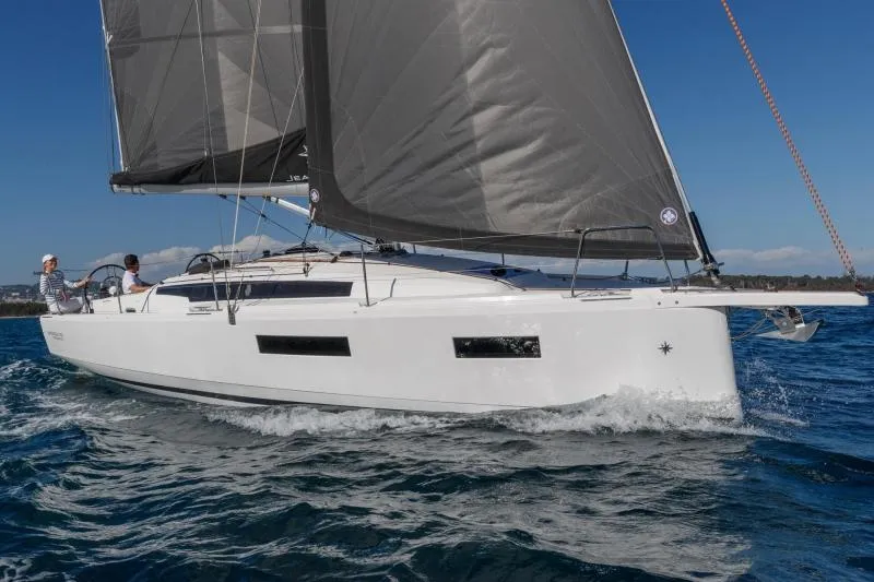 Slide: The Image of Manufacturer Provided Image: 2025 Jeanneau Sun Odyssey 350 sailing on open water, sleek design, white hull, black sails. - 99