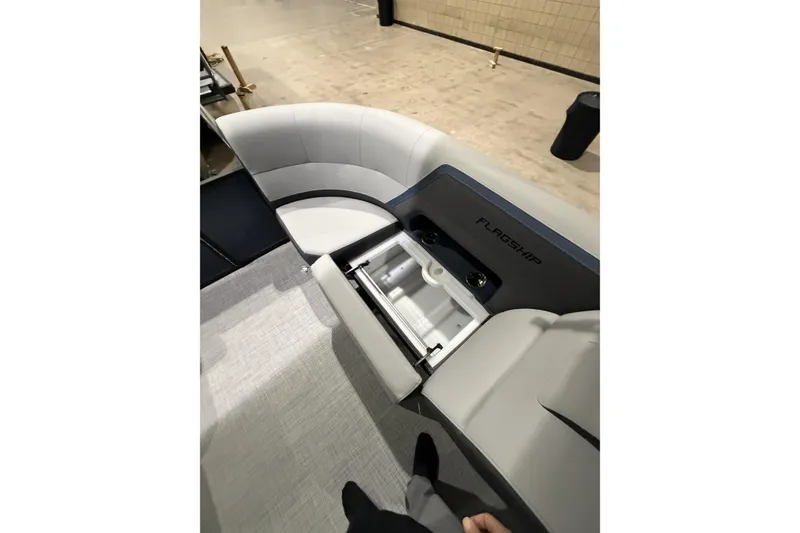 Slide: The Image of 2026 Flagship Discover 22CU boat interior with open storage compartment and seating. - 10