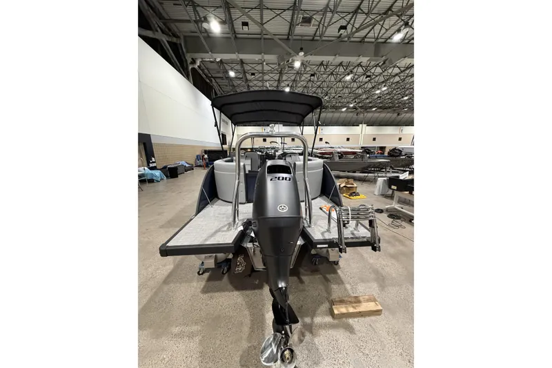 Slide: The Image of 2026 Flagship Discover 22CU boat with extended deck, showcased indoors. - 4