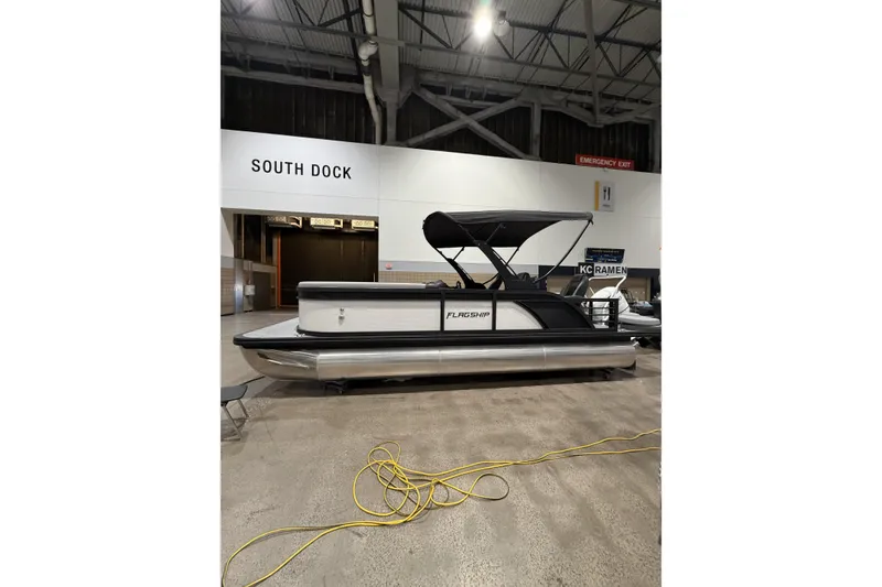Slide: The Image of 2026 Flagship Discover 22 pontoon boat with extended rear deck at indoor exhibition. - 5