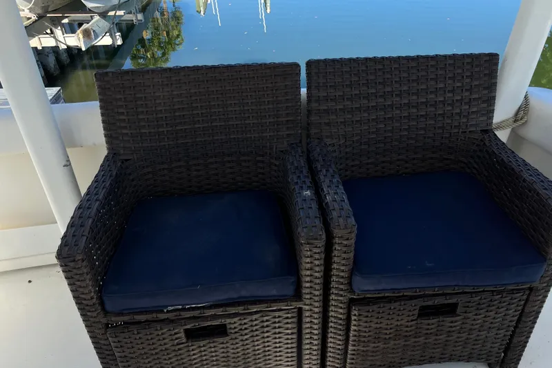 Slide: The Image of 2004 Cruisers Yachts 3750 Motoryacht with spacious seating, docked in a serene marina. - 17