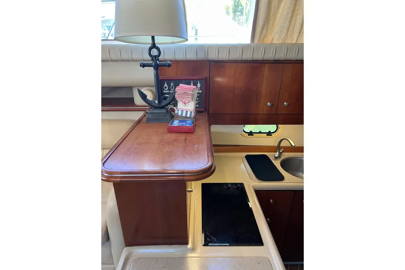 Slide: The Image of 2004 Cruisers Yachts 3750 Motoryacht interior with sink and speakers, docked by water. - 18