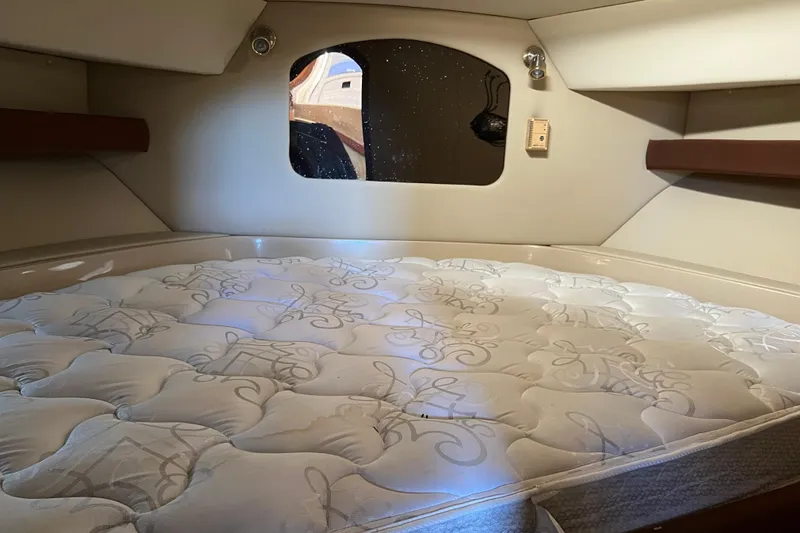 Slide: The Image of 2004 Cruisers Yachts 3750 Motoryacht interior with kitchenette and wooden cabinetry. - 21