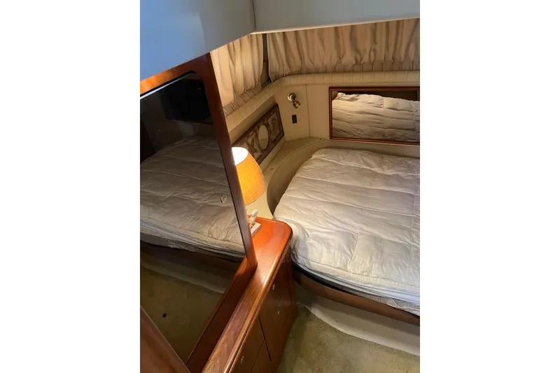 Slide: The Image of 2004 Cruisers Yachts 3750 Motoryacht interior with dining area, wooden table, and beige seating. - 28