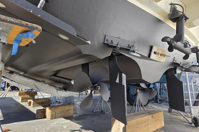 Slide: The Image of 2004 Cruisers Yachts 3750 Motoryacht under maintenance, showcasing propellers and hull details. - 38