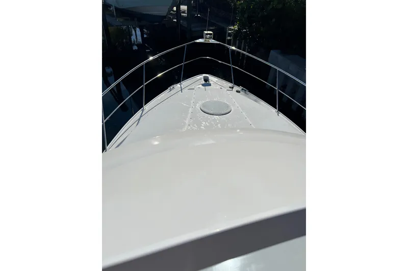 Slide: The Image of 2004 Cruisers Yachts 3750 Motoryacht docked under clear blue sky. - 4
