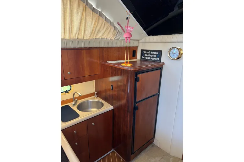 Slide: The Image of 2004 Cruisers Yachts 3750 Motoryacht interior with kitchenette and wooden cabinetry. - 19