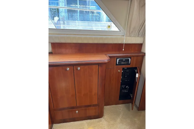 Slide: The Image of 2004 Cruisers Yachts 3750 Motoryacht interior with wooden cabinetry and audio system. - 26