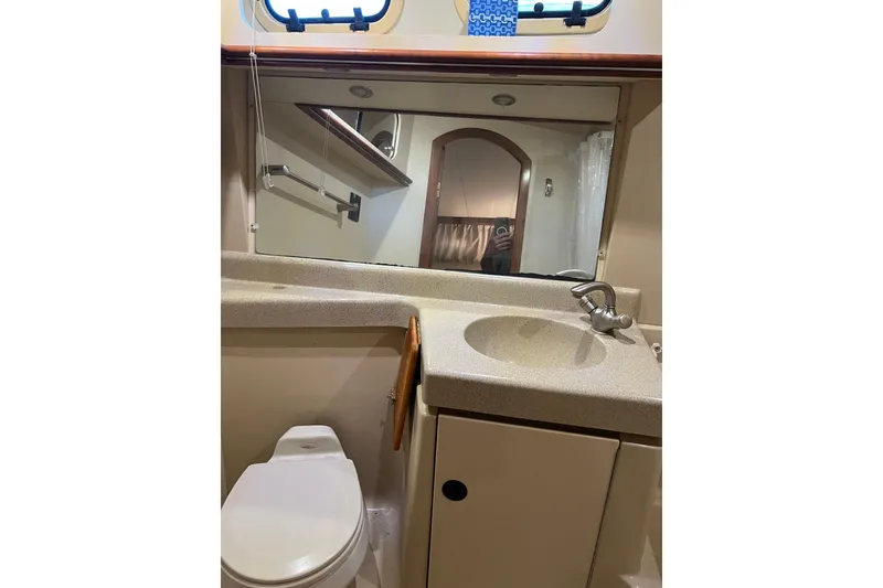 Slide: The Image of 2004 Cruisers Yachts 3750 Motoryacht bathroom with sink, mirror, and toilet. - 30