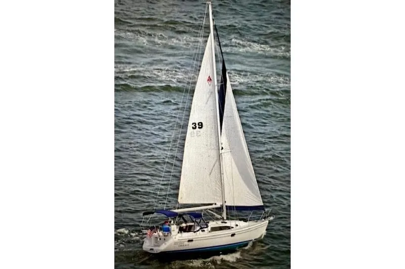 Slide: The Image of 2015 Catalina 315 sailboat navigating on open water with full sails. - 1