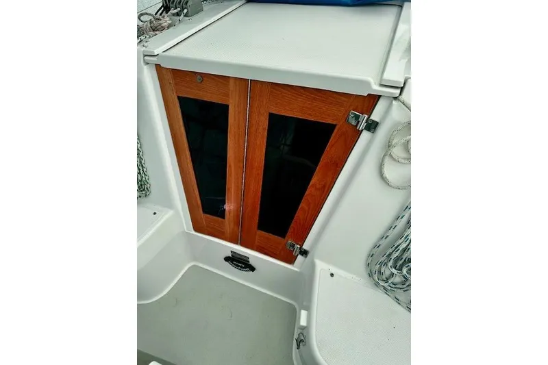 Slide: The Image of 2015 Catalina 315 sailboat cabin doors with wooden finish and nautical ropes. - 13