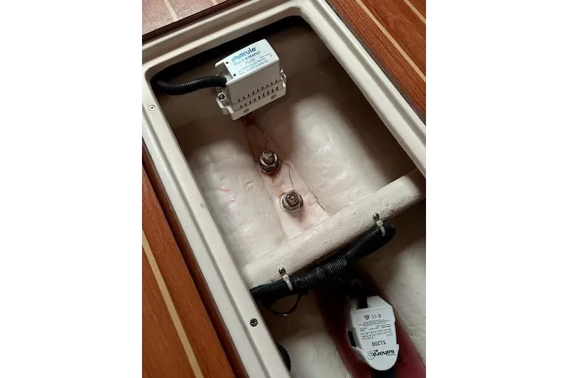 Slide: The Image of Electrical components inside a 2015 Catalina 315 boat, featuring wiring and connectors. - 20