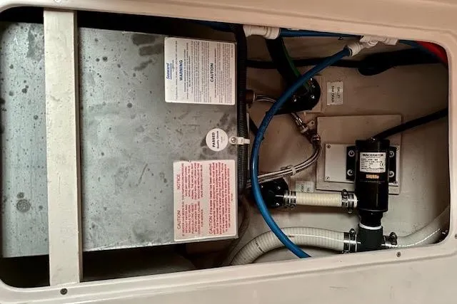 Slide: The Image of Engine compartment of a 2015 Catalina 315 sailboat, featuring various mechanical components. - 22