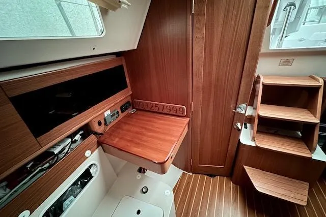 Slide: The Image of Interior of 2015 Catalina 315 sailboat with wooden cabinetry and foldable table. - 35