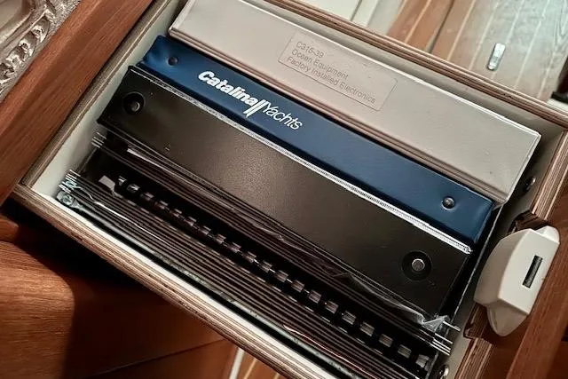 Slide: The Image of Drawer containing Catalina Yachts manuals and documents for a 2015 Catalina 315 model. - 40