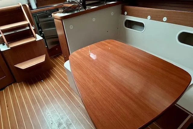 Slide: The Image of 2015 Catalina 315 yacht interior with wooden table and stairs. - 41
