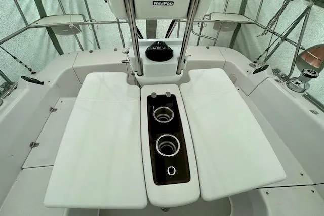 Slide: The Image of Cockpit of 2015 Catalina 315 sailboat with dual cup holders and white seating. - 44