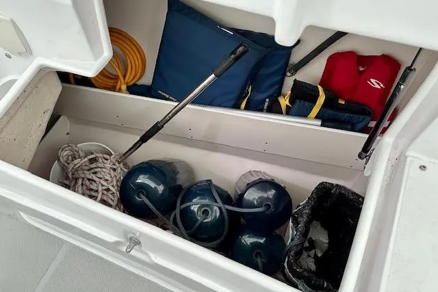 Slide: The Image of Storage compartment of 2015 Catalina 315 sailboat with ropes, fenders, and life jackets. - 47