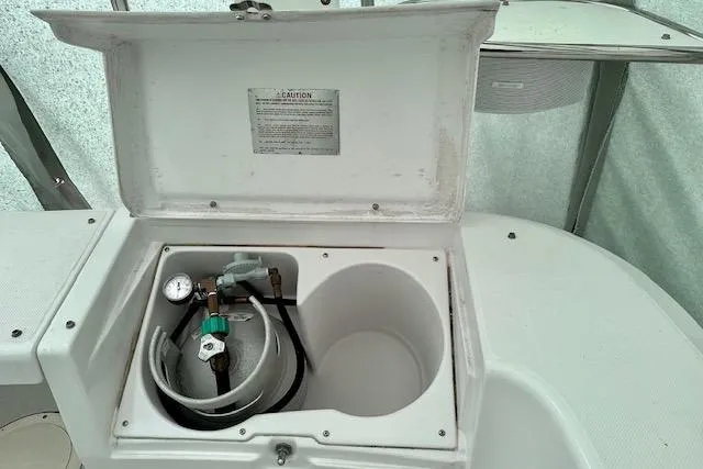 Slide: The Image of Open storage compartment on 2015 Catalina 315 boat with gas cylinder and gauge. - 48