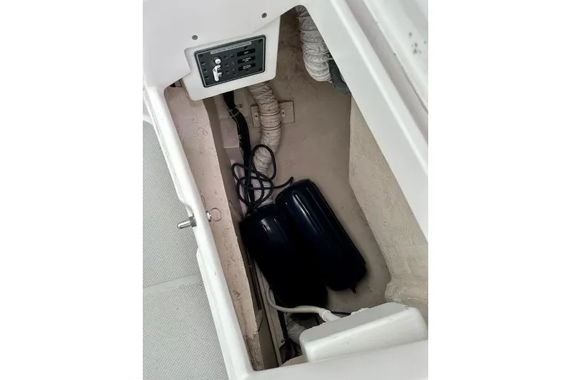 Slide: The Image of Storage compartment of a 2015 Catalina 315 sailboat with control panel and equipment. - 49