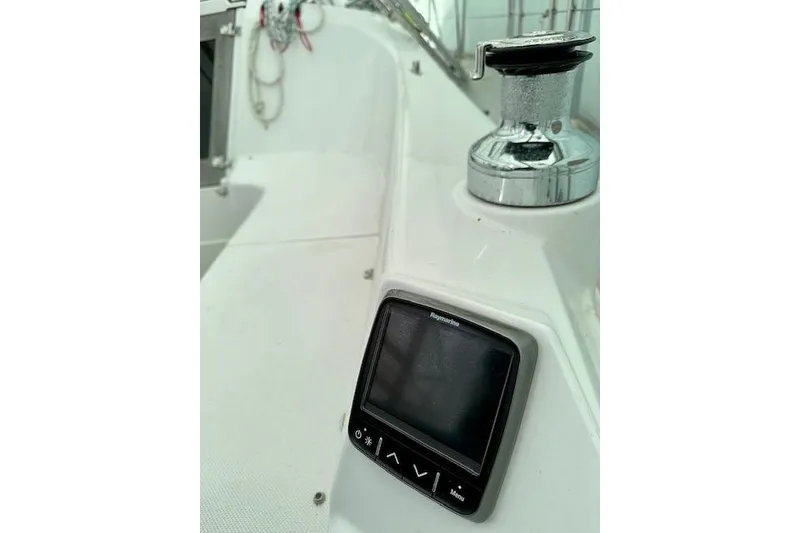Slide: The Image of Close-up of a 2015 Catalina 315 sailboat cockpit with navigation display and winch. - 50