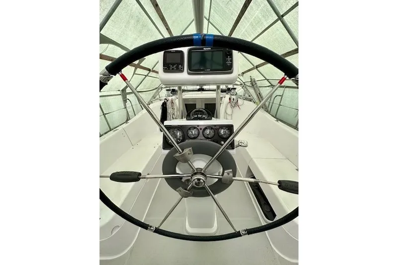 Slide: The Image of Steering wheel and dashboard of a 2015 Catalina 315 sailboat under a canopy. - 52