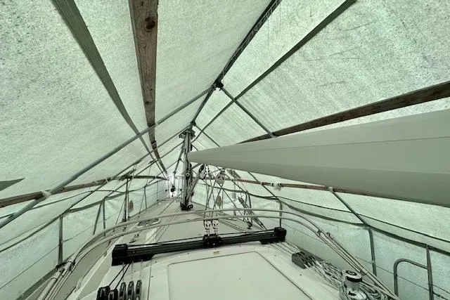 Slide: The Image of Covered 2015 Catalina 315 sailboat under protective tarp, showcasing deck and rigging. - 54