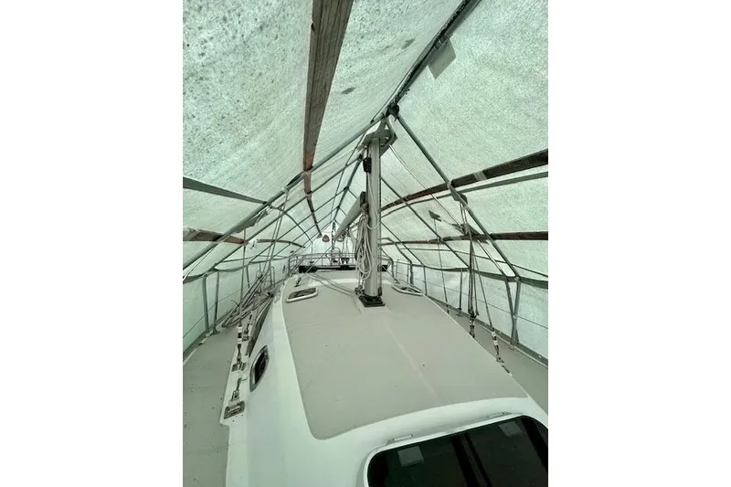 Slide: The Image of 2015 Catalina 315 sailboat under protective cover, view of deck and rigging. - 60