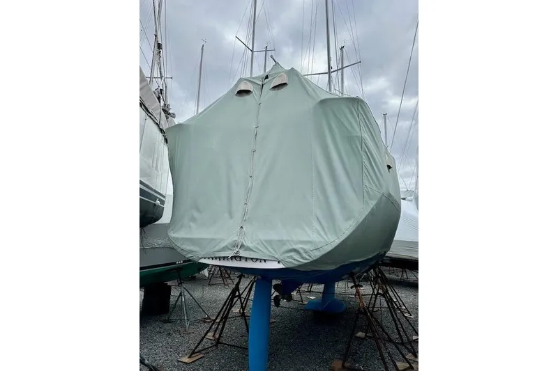 Slide: The Image of Covered 2015 Catalina 315 sailboat on stands under cloudy sky. - 62