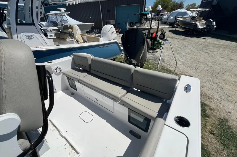 Slide: The Image of 2026 Sportsman Heritage 231 Center Console boat with cushioned seating and modern design. - 11