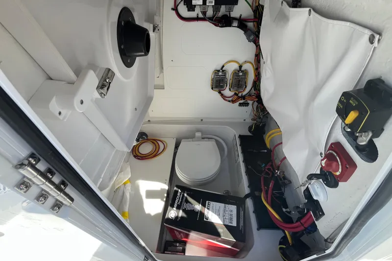 Slide: The Image of Interior view of 2026 Sportsman Heritage 231 Center Console boat's electrical and storage compartment. - 13