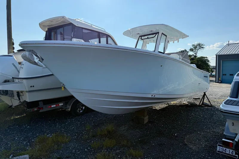 The Image of 2026 Sportsman Open 262 Center Console boat displayed outdoors on a sunny day. - 0