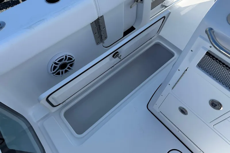 Slide: The Image of 2026 Sportsman Open 262 Center Console boat storage compartment and speaker detail. - 11