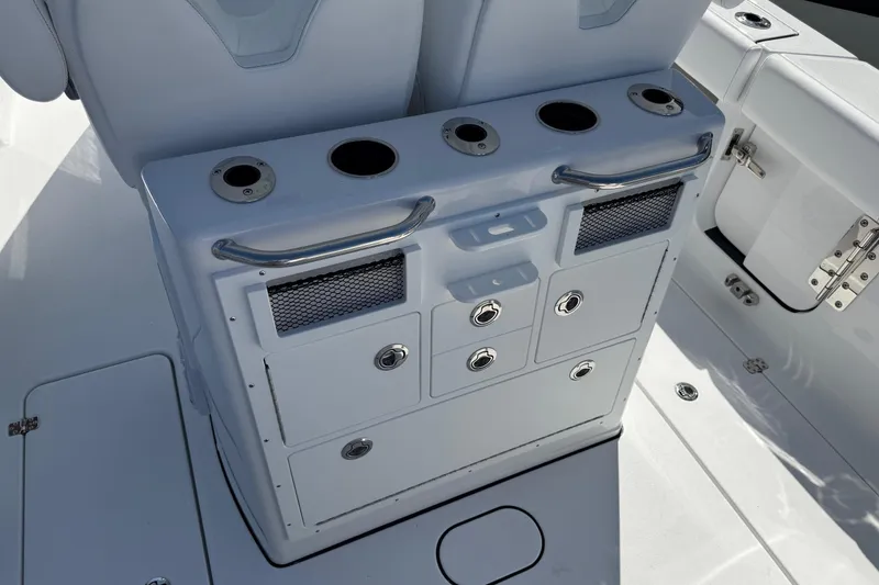 Slide: The Image of 2026 Sportsman Open 262 Center Console boat interior with storage compartments and cup holders. - 12