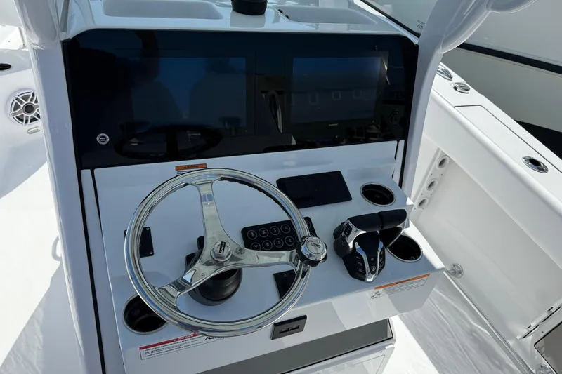 Slide: The Image of 2026 Sportsman Open 262 Center Console boat dashboard with steering wheel and controls. - 14