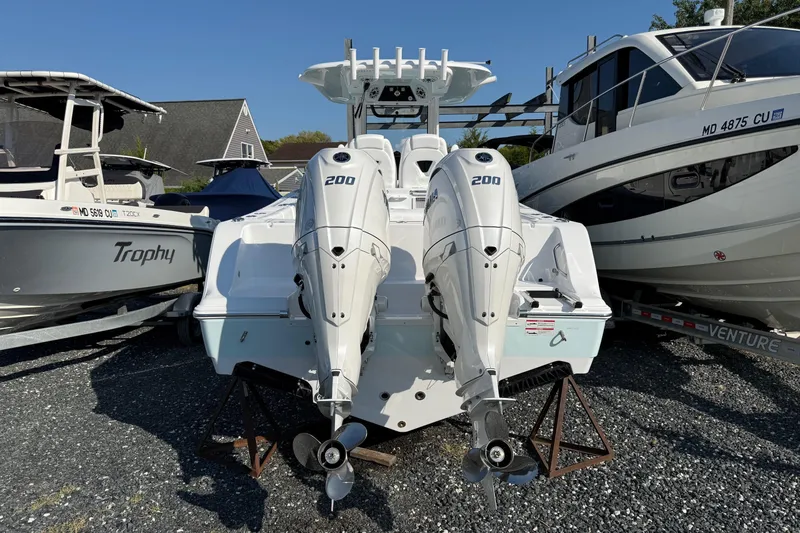 Slide: The Image of 2026 Sportsman Open 262 Center Console with dual 200 horsepower engines, docked among other boats. - 3