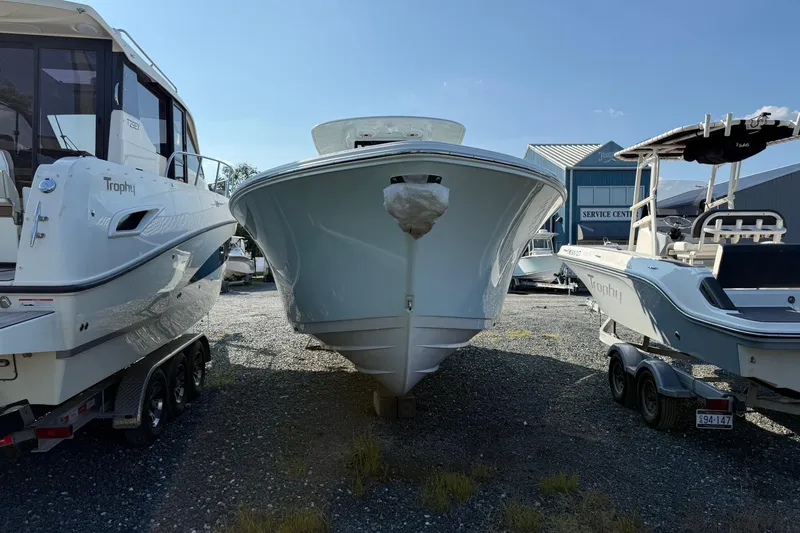Slide: The Image of 2026 Sportsman Open 262 Center Console boat in a marina, flanked by other vessels. - 5