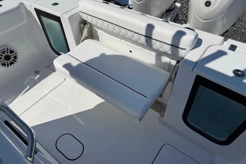 Slide: The Image of 2026 Sportsman Open 262 Center Console boat interior with white seating and storage. - 7