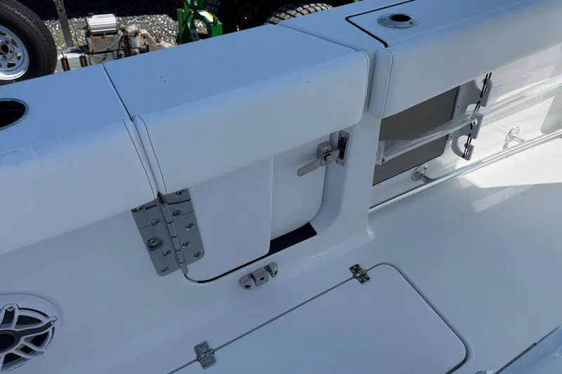 Slide: The Image of 2026 Sportsman Open 262 Center Console boat interior with storage compartments and speaker. - 9