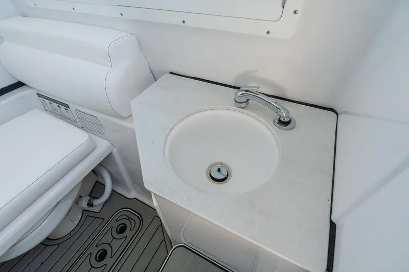 Slide: The Image of Manufacturer Provided Image: 2025 Sportsman Open 302 Center Console bathroom with sink and toilet. - 15