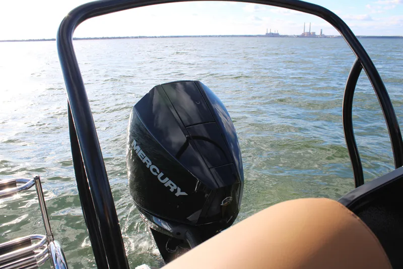 Slide: The Image of 2026 Premier 230 SunSation RF with Mercury outboard motor on open water. - 18