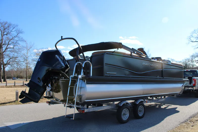 Slide: The Image of 2026 Premier 230 SunSation RF pontoon boat on trailer, parked outdoors. - 2