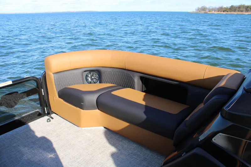 Slide: The Image of Luxurious seating on 2026 Premier 230 SunSation RF pontoon boat, overlooking serene blue waters. - 4