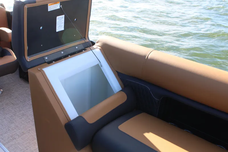 Slide: The Image of 2026 Premier 230 SunSation RF boat with open storage compartment on water. - 5