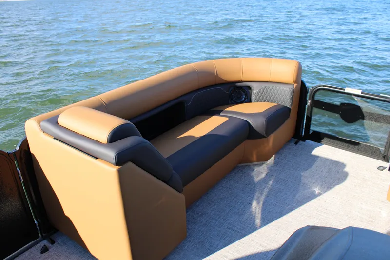 Slide: The Image of Luxurious seating on 2026 Premier 230 SunSation RF pontoon boat, overlooking serene water. - 7