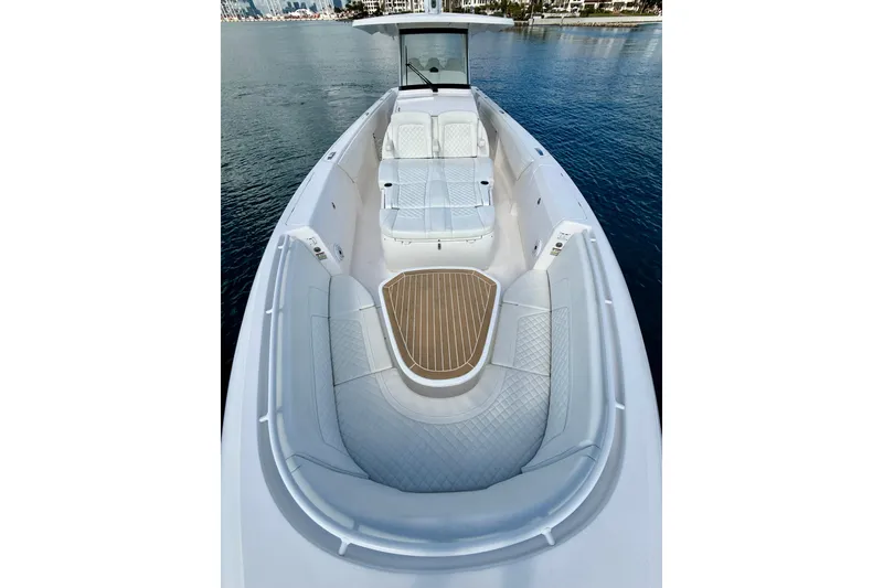 Slide: The Image of 2022 Intrepid 407 Nomad SE boat with spacious seating and elegant design on the water. - 11
