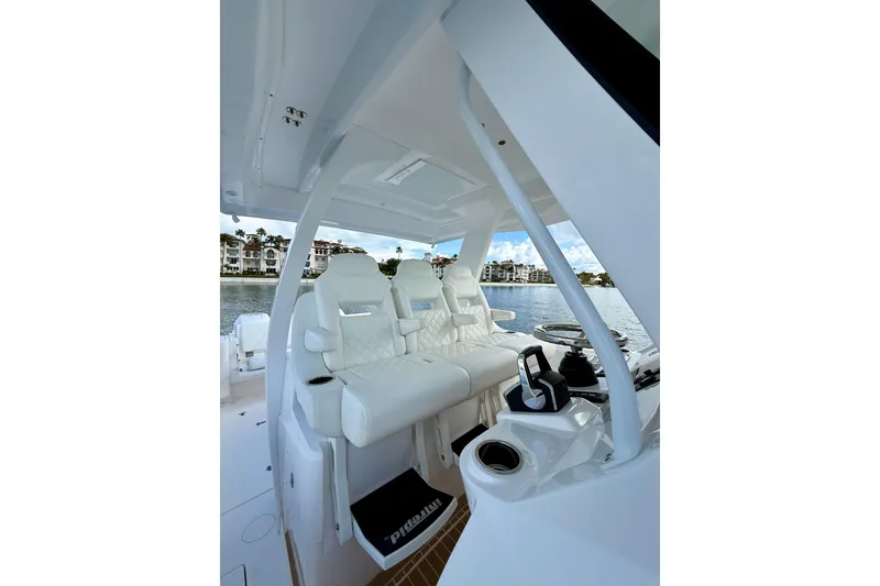 Slide: The Image of Interior of 2022 Intrepid 407 Nomad SE boat with luxurious seating and waterfront view. - 18