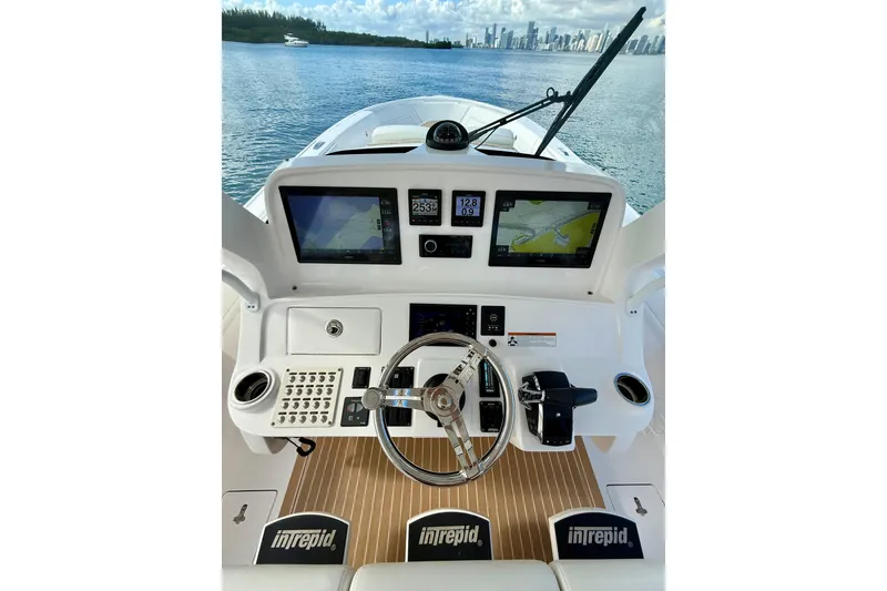 Slide: The Image of 2022 Intrepid 407 Nomad SE boat dashboard with navigation screens and steering wheel. - 20